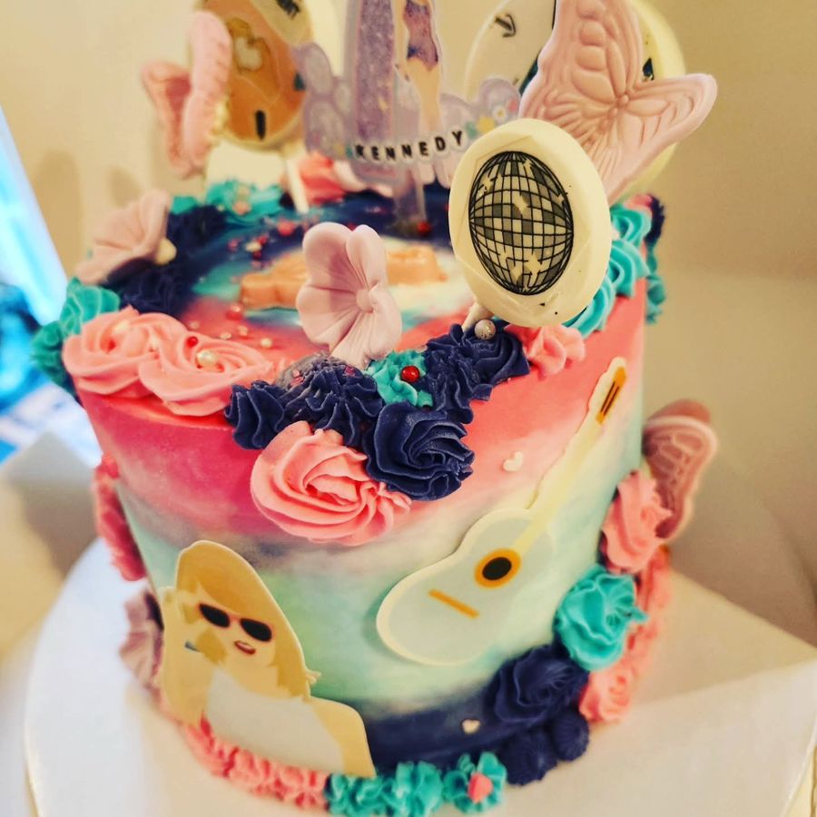 Pop star concert birthday cake with butterflies, a guitar and a disco ball