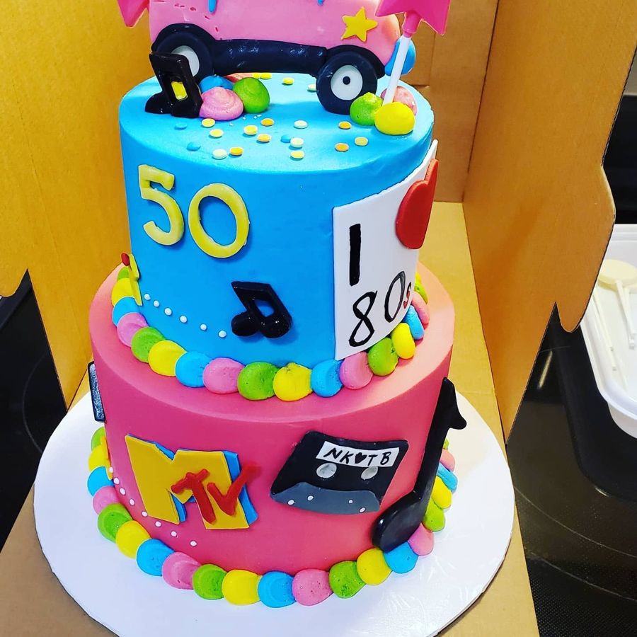 Two-tier I love the 80s 50th birthday cake with cassette, MTV and music notes