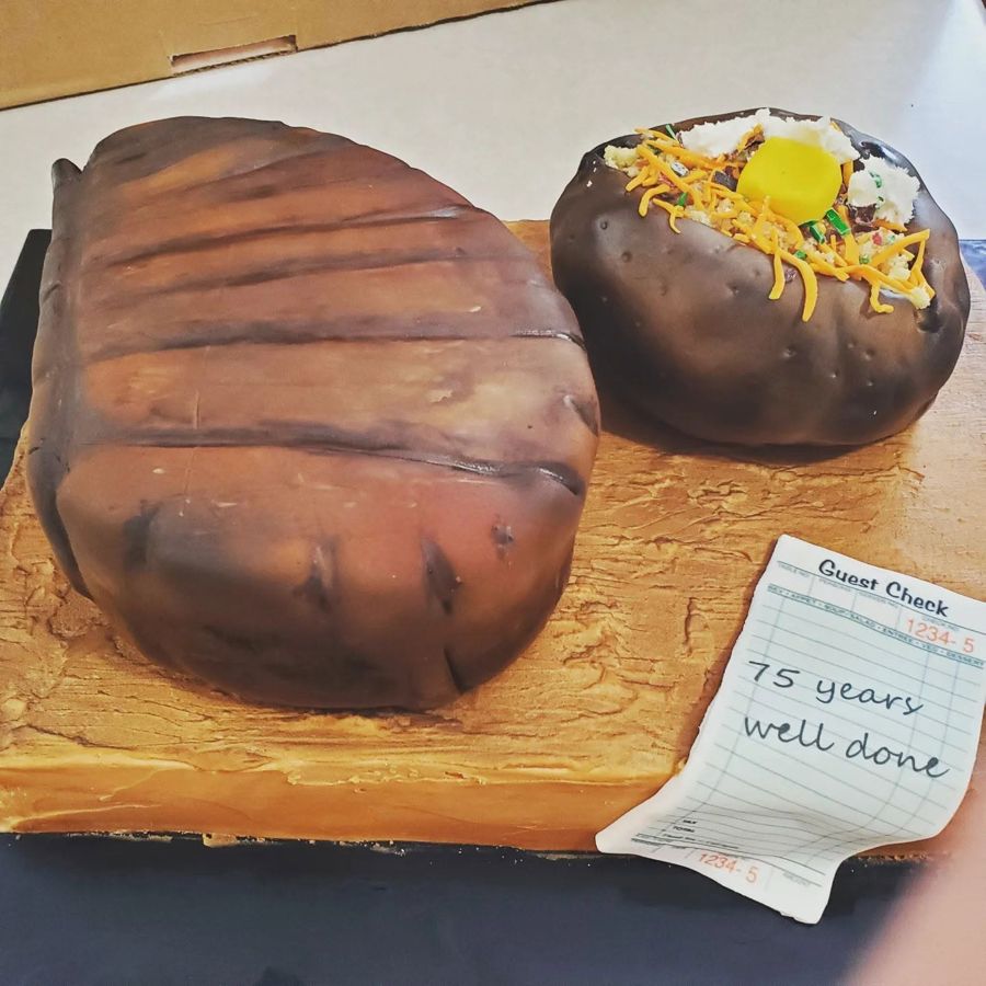 Steak and loaded baked potato cake with a 75 years well done guest check